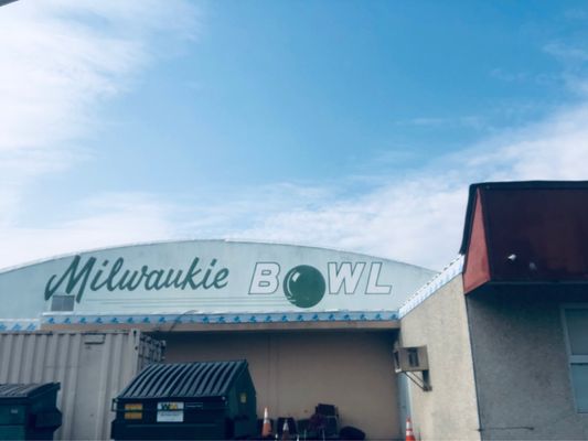 The exterior building signage for Milwaukie Bowl under a bright blue sky.