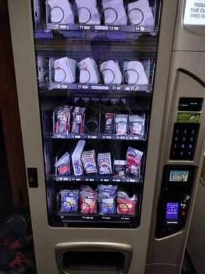 A vending machine at a bowling alley stocked with socks and bowling accessories.