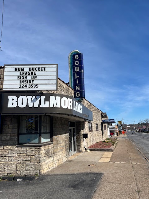 Exterior view of Bowlmor Lanes featuring a stone facade and a marquee sign for league sign-ups.
