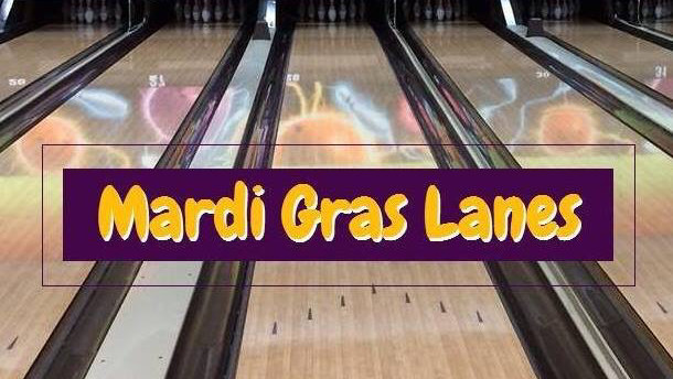 A view down several bowling lanes with a purple banner that reads Mardi Gras Lanes.