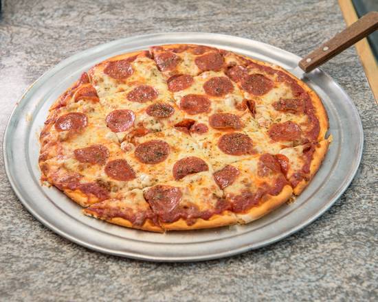 A freshly baked pepperoni pizza cut into square slices on a metal tray.