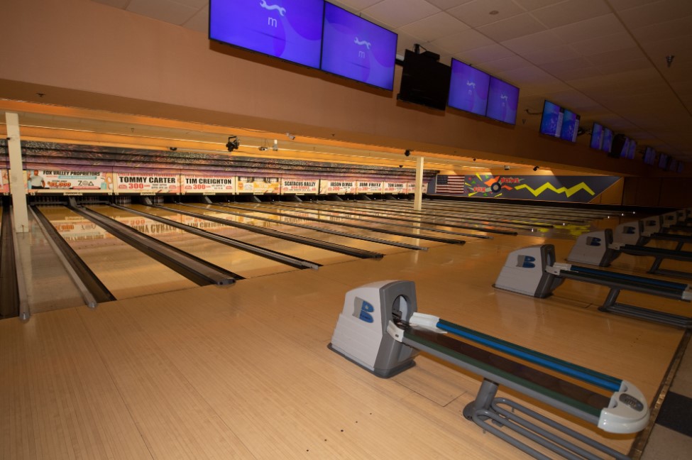 View of multiple bowling lanes at Fox Bowl featuring league achievement banners above the pins.