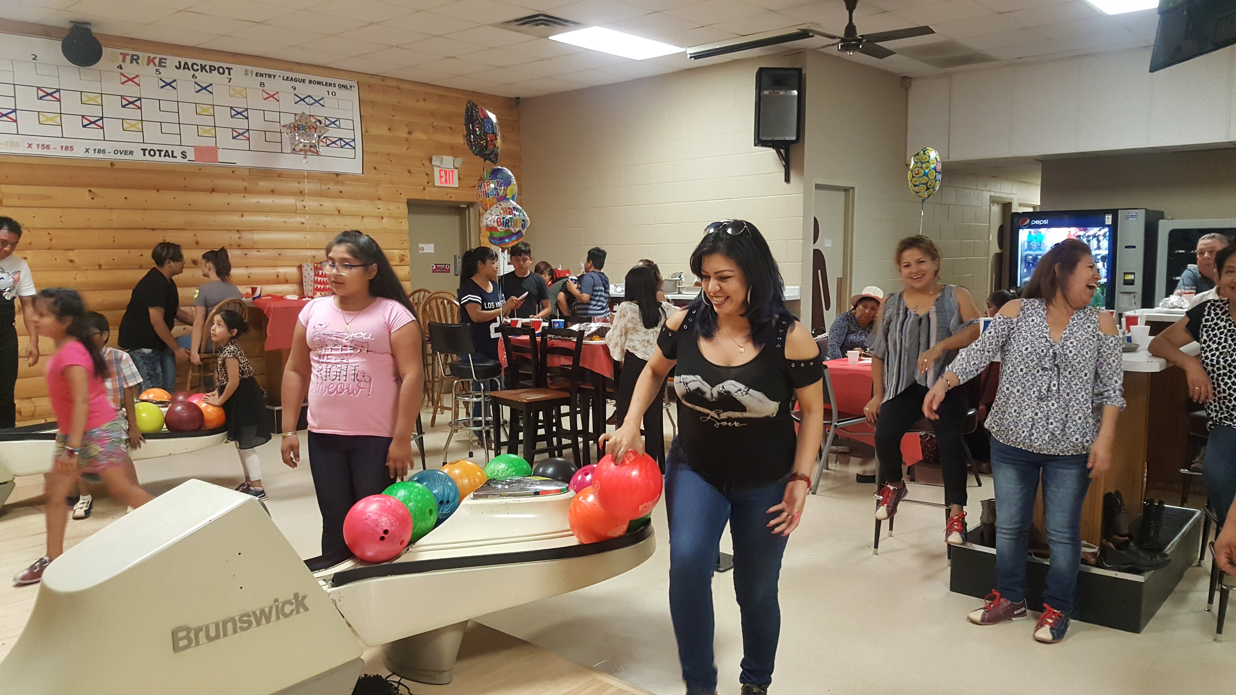 People laughing and bowling during a group party at Lakeside Lanes.