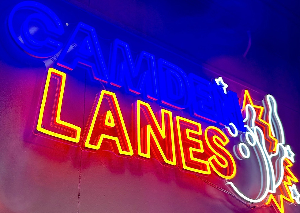 A vibrant neon sign for Camden Lanes in blue, red, and yellow, with a bowling ball and pins graphic.