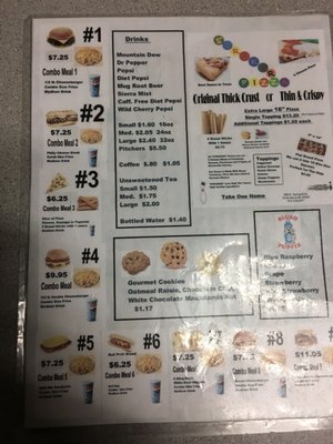 A printed snack bar menu showing various combo meals, pizza options, and drink prices.