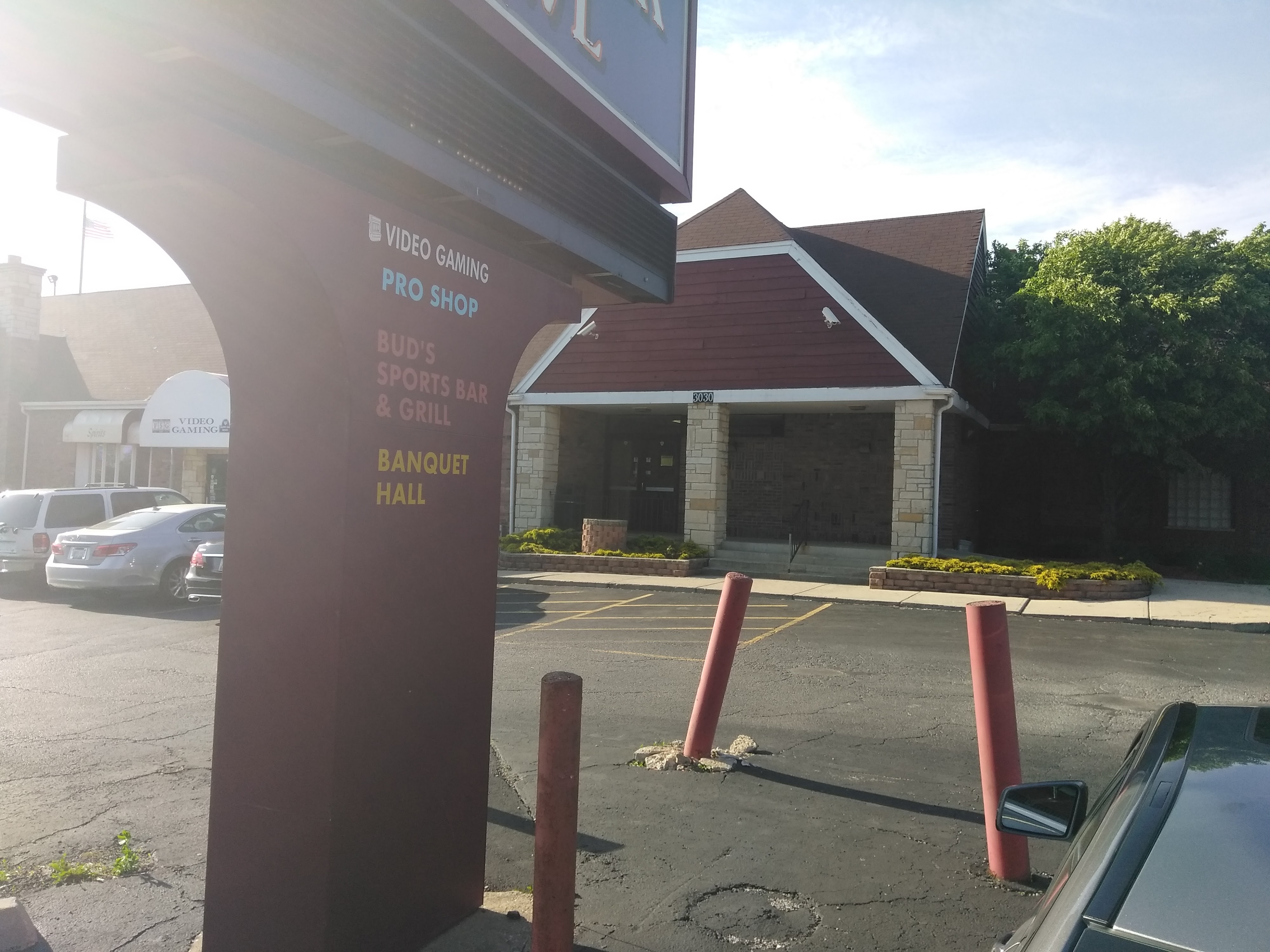 Exterior of Burr Oak Bowl building and a large pylon sign listing the pro shop and bar and grill.