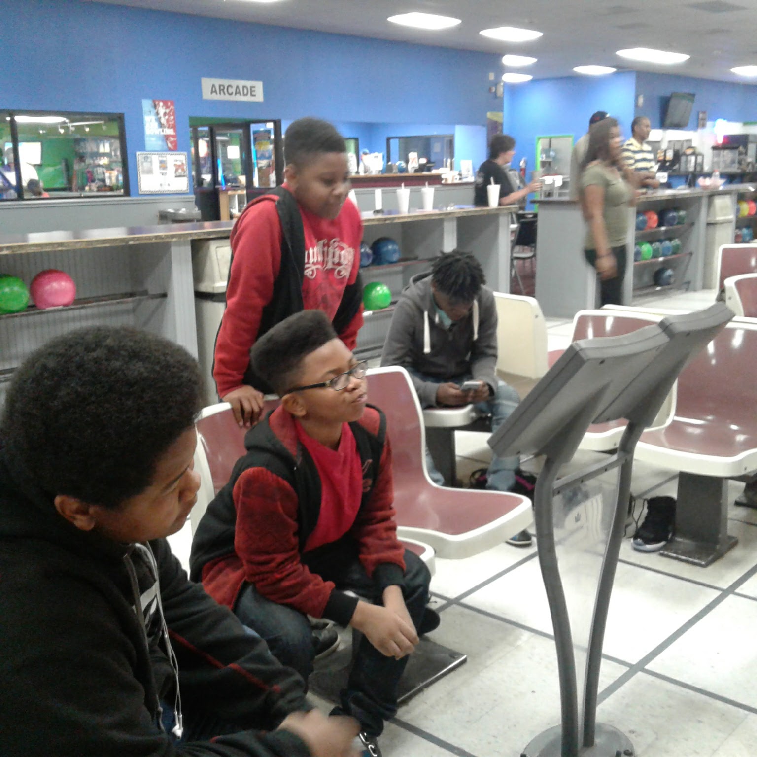Three young boys look at a digital bowling score monitor at Sandhills Bowling Center.