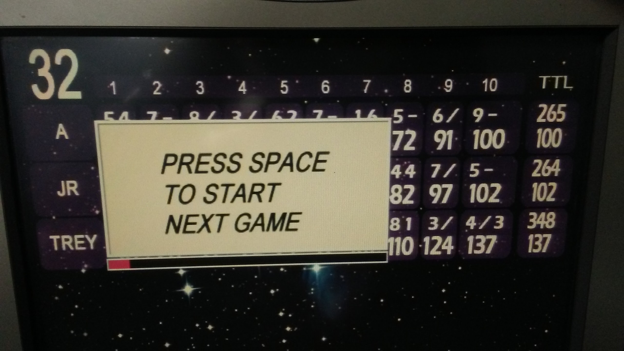 A bowling score monitor for lane thirty-two displaying three player names and a prompt to start the next game.