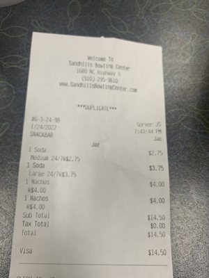 A printed paper snack bar receipt from Sandhills Bowling Center on a gray patterned tabletop.