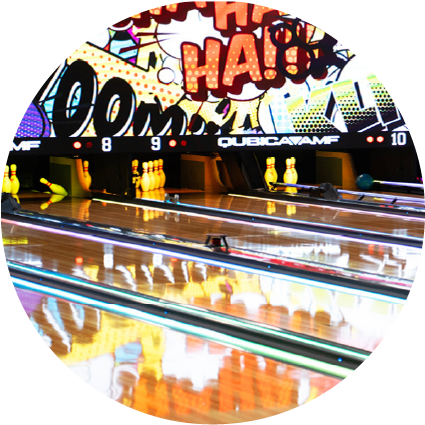 A circular view of bowling lanes with vibrant comic-book graphics and colorful light reflections on the wood.