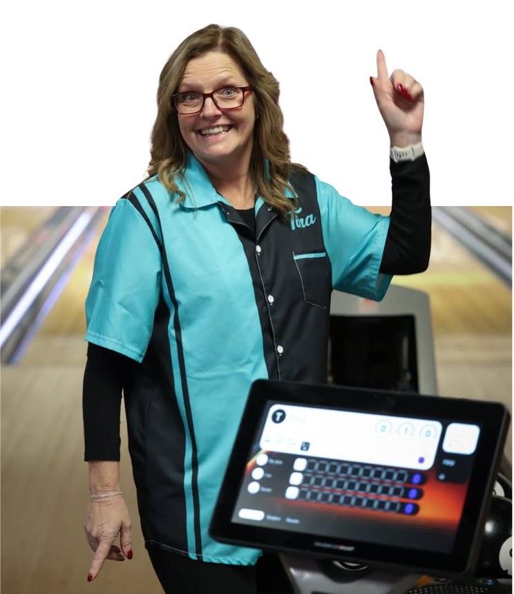 A smiling woman in a teal bowling shirt points to an automatic scoring tablet with bowling lanes in the background.