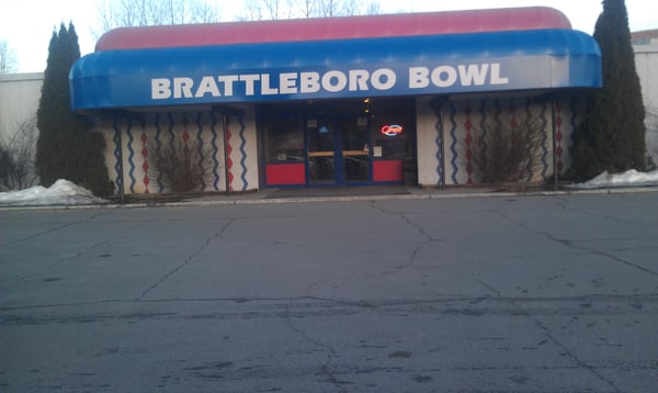 Exterior view of the Brattleboro Bowl entrance with a large blue and red awning.